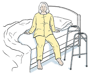 Person preparing to lie down in bed, with walker by bed.