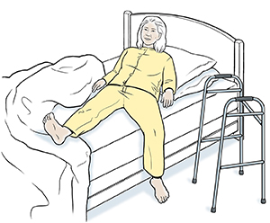 Person lying down in bed, with walker by bed.