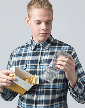 Man holding box of condoms.